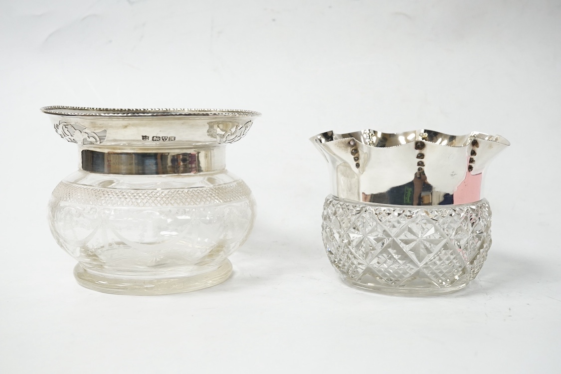 An Edwardian silver mounted glass preserve pot, Nathan & Hayes, Chester, 1903 and a larger similar pot by Nathan & Hayes, Chester, 1913, height 98mm, both lacking covers. Condition - fair to good